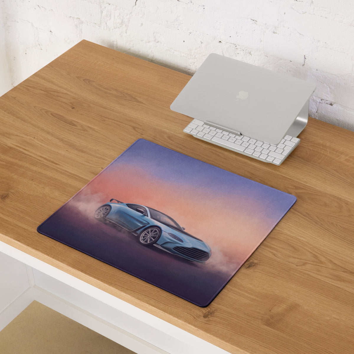 Aston Martin vantage inspired sky blue gt3 extended desk pad with sleek glossy finish and vibrant sunset backdrop