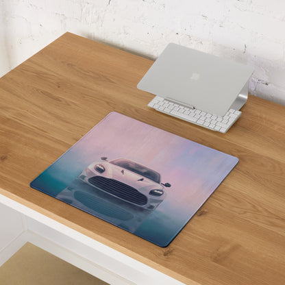 A rectangular ultra-glide stitched edge desk pad featuring a white Aston Martin Vantage graphic against a gradient sky