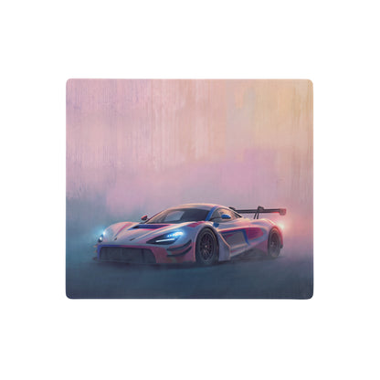 A mcLaren 720S GT3 inspired neon track desk pad featuring a sleek pink and blue futuristic race car design with stitched edges