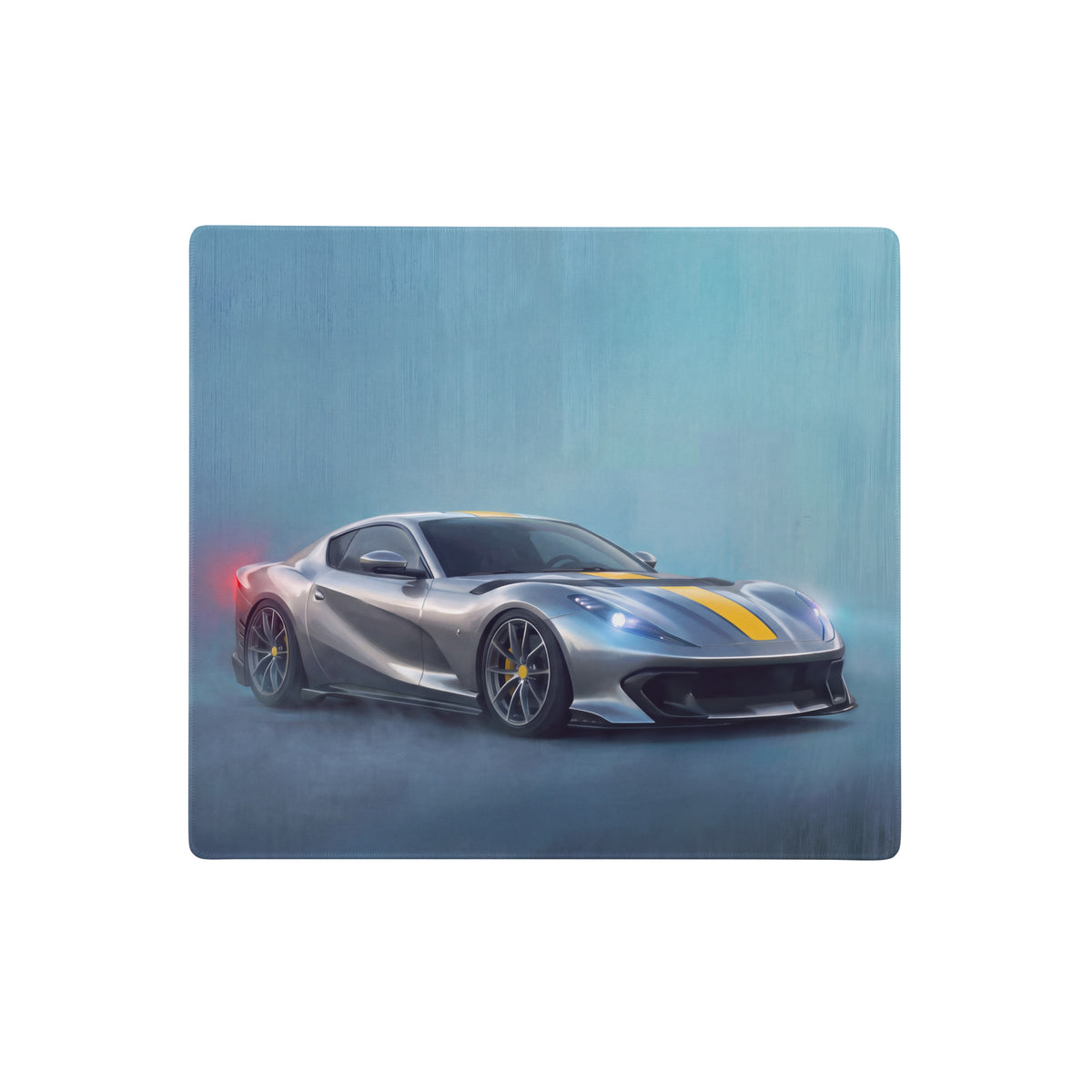 Silver ferrari 812 superfast with yellow racing stripes and black rims on a giallo desk pad with non-slip base