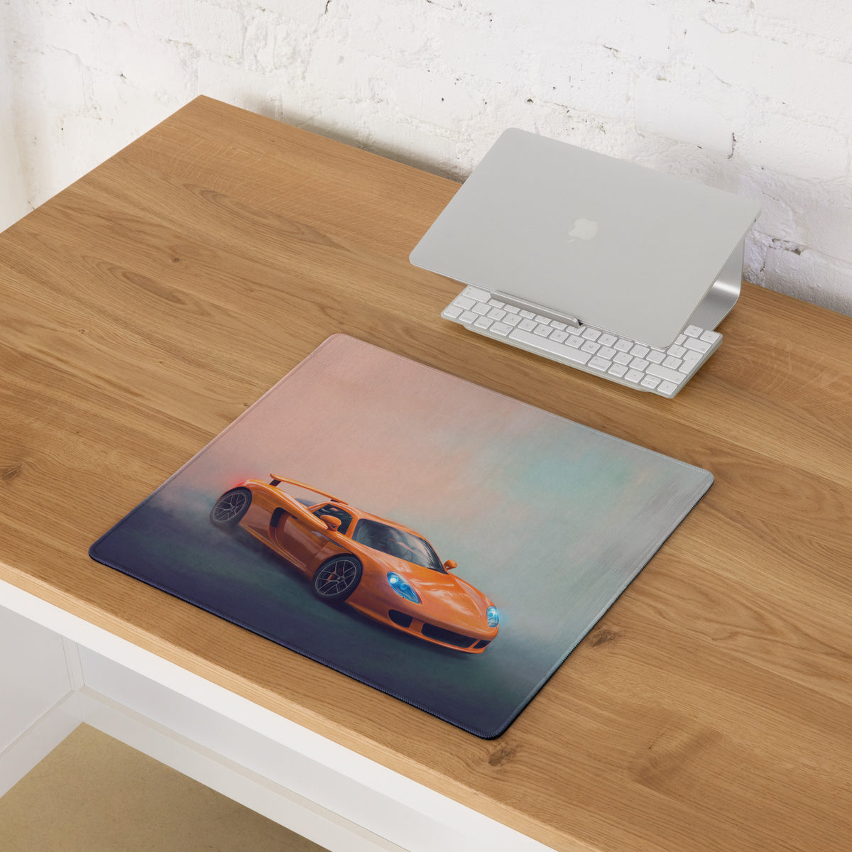 Porsche Carrera GT inspired Arancio edition desk mat with orange sports car graphic on ultra-glide cloth mousepad