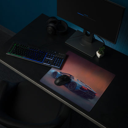 A sleek rectangular non-slip rubber gaming mousepad featuring a blue sports car graphic and orange purple gradient background