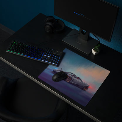 A sleek rectangular pagani huayra r inspired gold leaf desk pad with vibrant silver sports car graphic and stitched edge