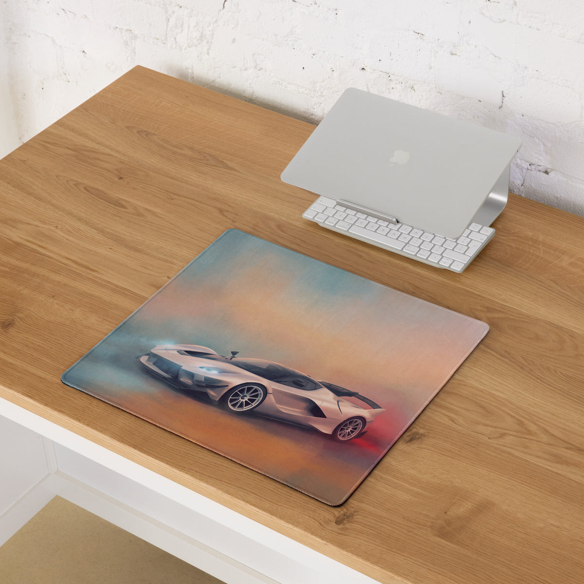 Rectangular xl low-friction gaming mousepad with a detailed white ferrari fxx-k evo sports car on blue orange gradient background