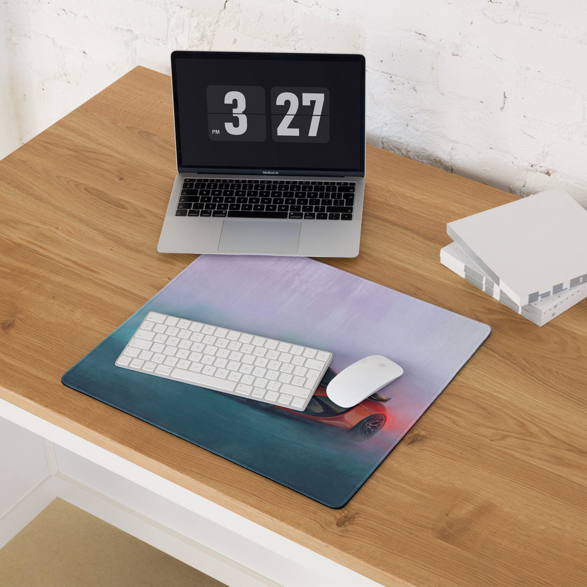 Mclaren p1 inspired volcanic sunset desk pad featuring a red sports car graphic on a non-slip rubber mouse mat with white keyboard and mouse