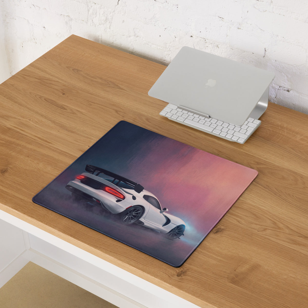 Rectangular stitched edge mousepad featuring a white dodge viper acr inspired sports car on a dark blue to pink gradient background