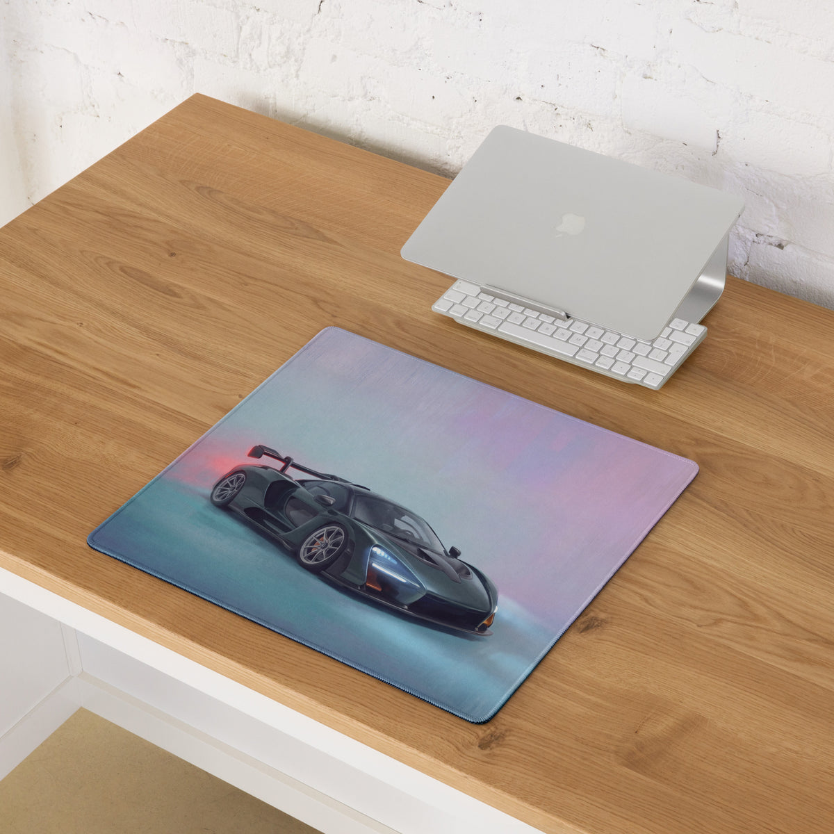 Rectangular mcLaren senna inspired racing green desk pad featuring a glossy black sports car with red taillights