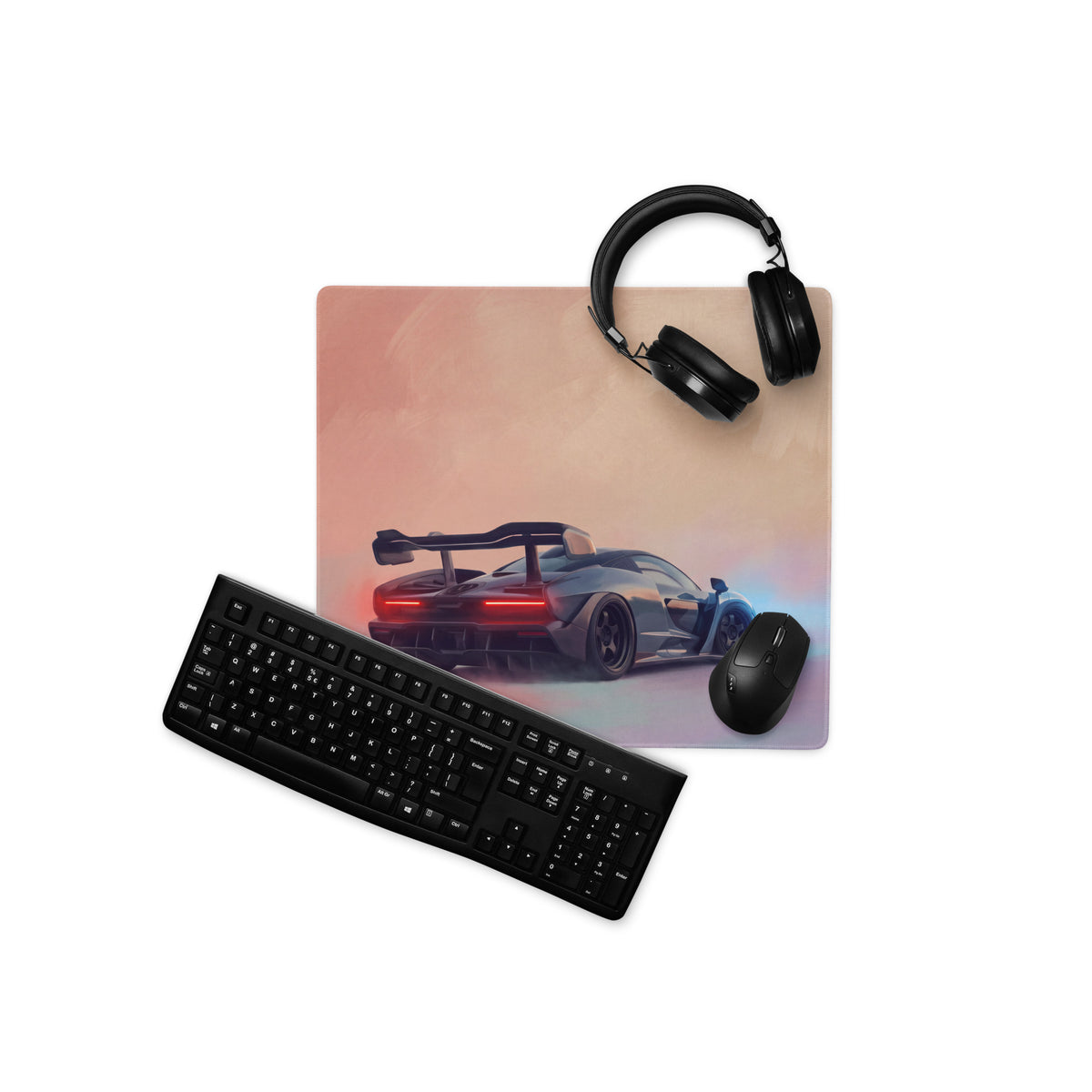 Rectangular gaming mousepad with sleek black mclaren senna car design on non-slip rubber base against peach background