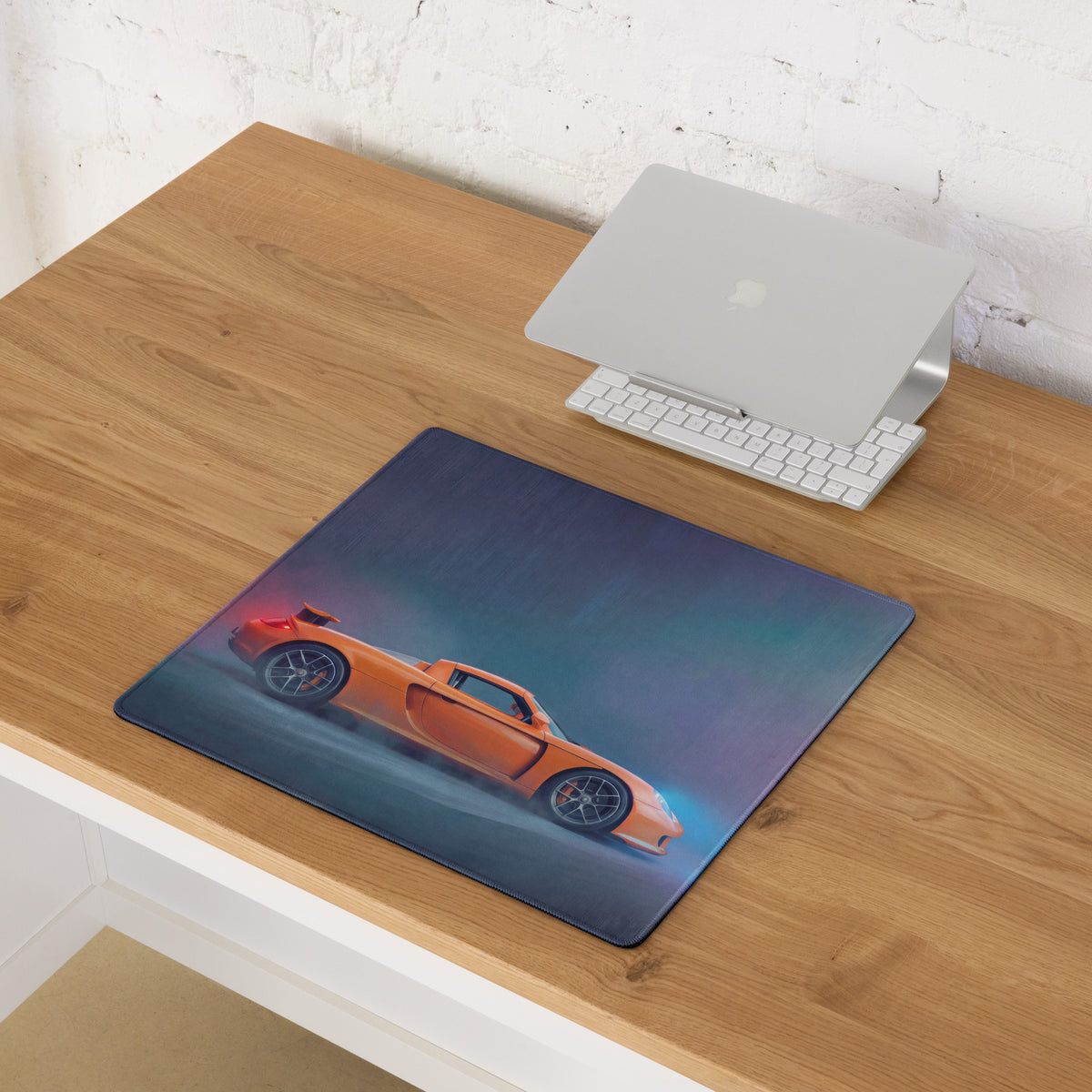 Orange sports car graphic on dark blue rectangular porsche carrera gt inspired sunset orange desk mat mousepad
