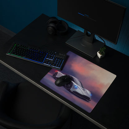 A rectangular silver gaming mousepad with a vibrant white sports car and blue headlights for low-friction PC setups