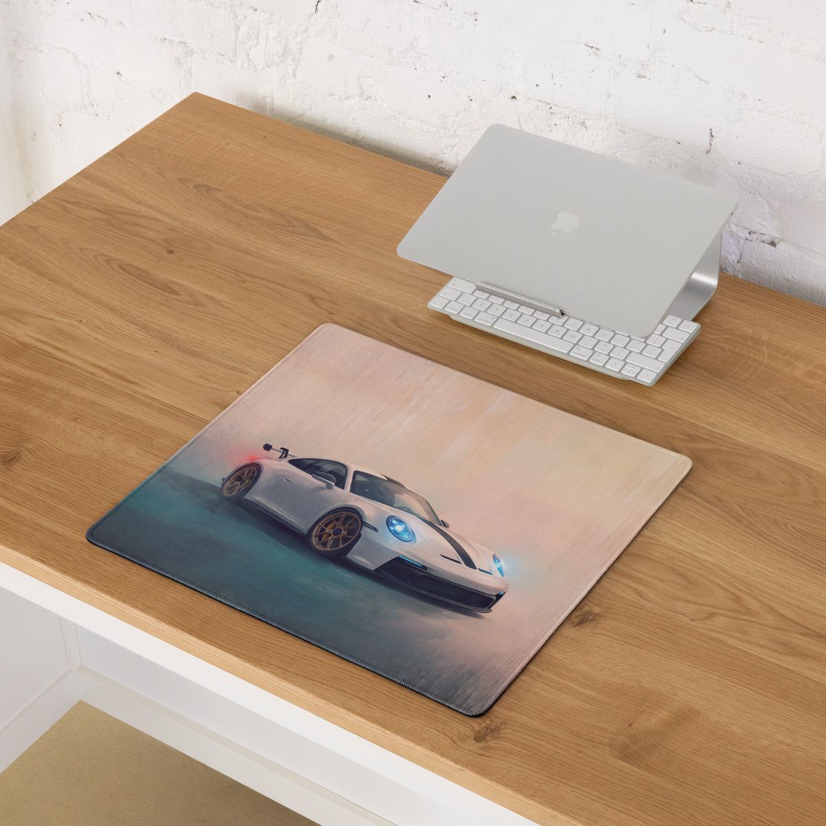 Rectangular Porsche 911 GT3 inspired white gold desk pad with detailed white sports car graphic and non-slip rubber base
