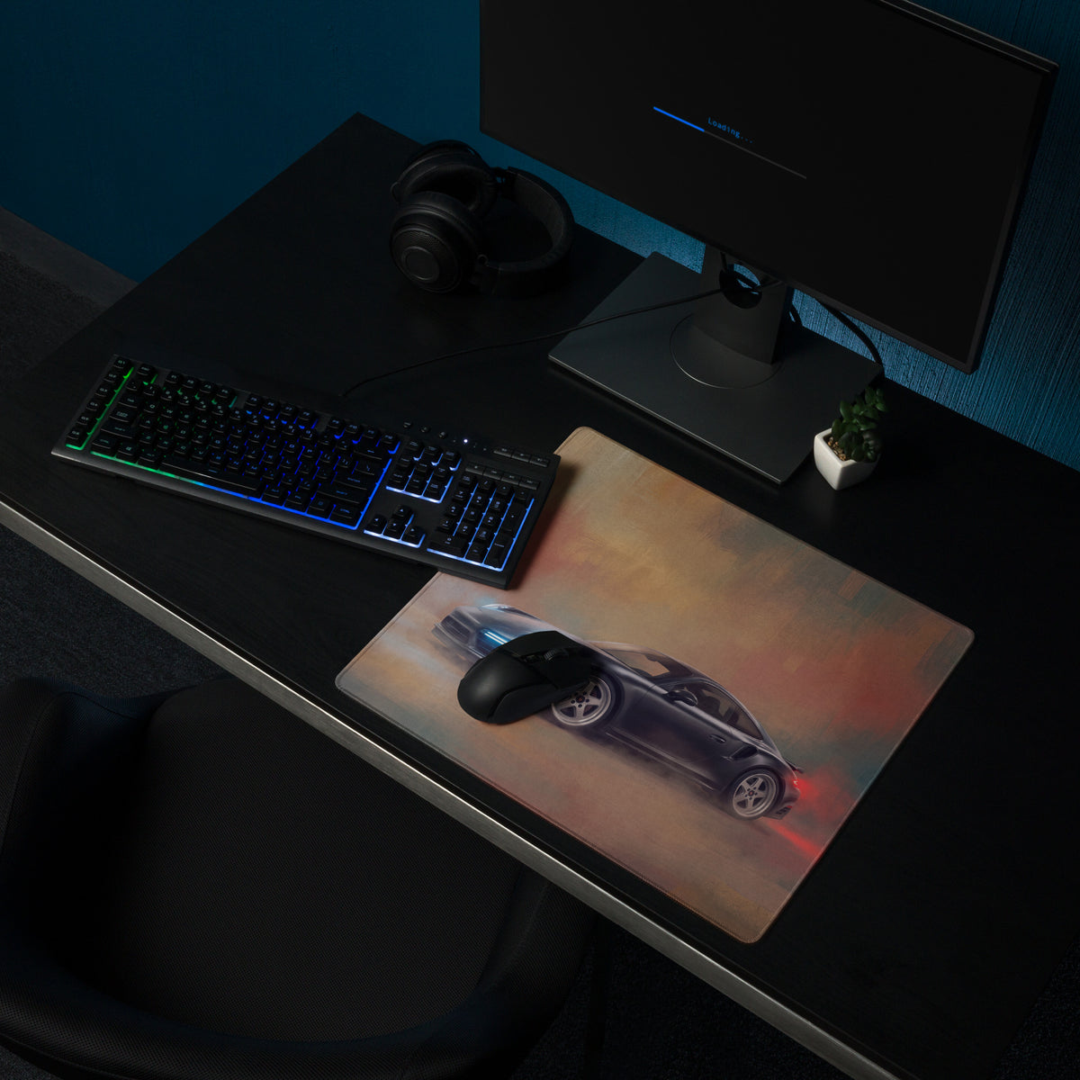 Black gaming mouse on a slate grey Porsche 911 Turbo inspired desk mat with blue and red glowing sports car graphic