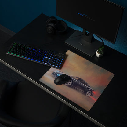 Black gaming mouse on a slate grey Porsche 911 Turbo inspired desk mat with blue and red glowing sports car graphic