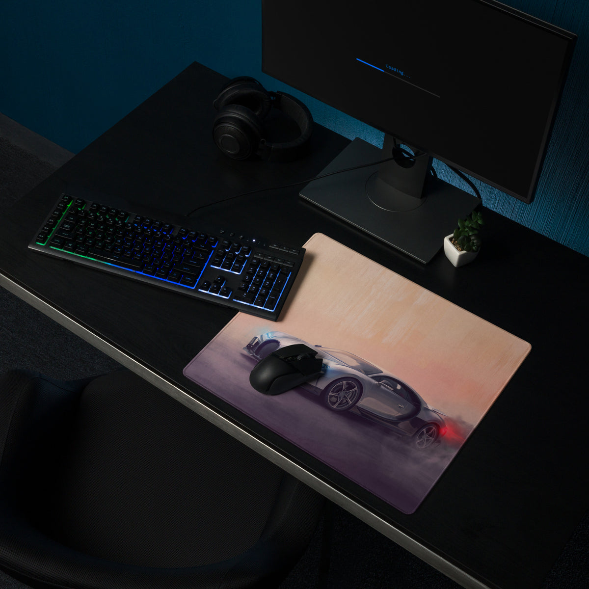 A sleek rectangular silver gaming mousepad featuring a silver sports car with glowing red taillights at sunset