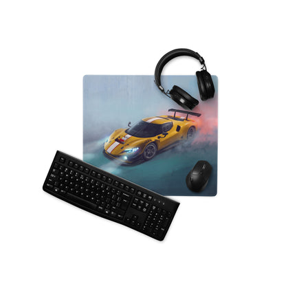 Yellow racing car graphic ferrari 296 gt3 inspired giallo apex low-friction cloth desk mat with black headphones and keyboard nearby