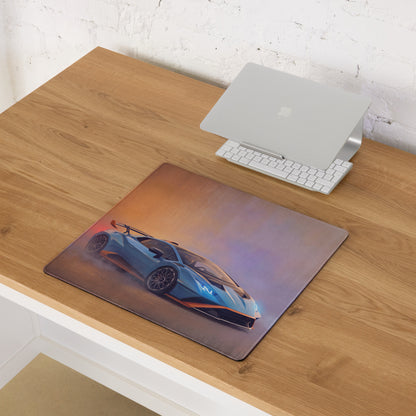 Rectangular lamborghini huracán sto inspired gulf edition desk pad featuring blue and orange car on sunset gradient background