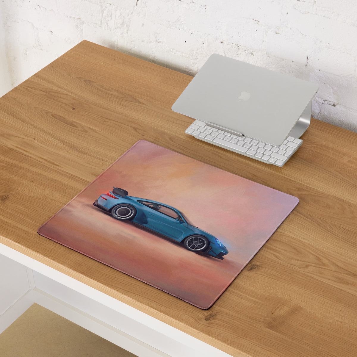 Blue sports car illustration on rectangular porsche 911 gt3 inspired riviera sunset desk mat with pink orange gradient