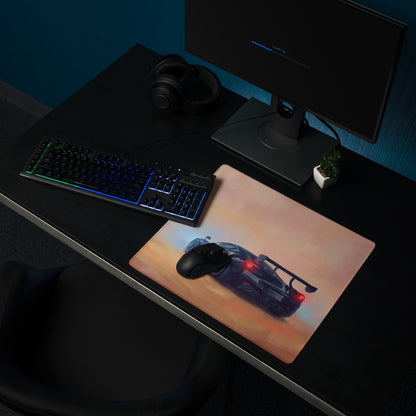 A rectangular high-precision xl gaming mousepad featuring a dark gray mclaren senna with red taillights on a papaya sunset background