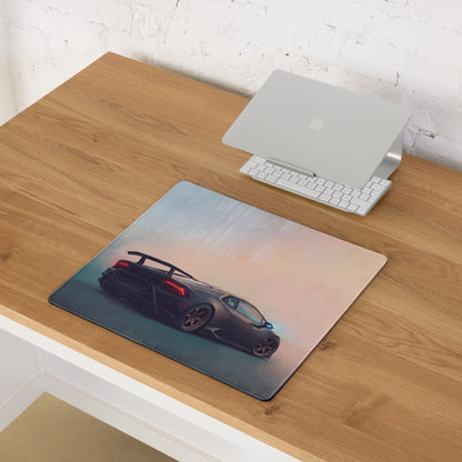 Rectangular stealth bronze desk mat featuring a dark gray lamborghini huracán with red taillights against gradient sky