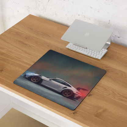 Rectangular non-slip desk pad featuring a white Porsche 911 GT3 RS inspired sports car on a dark smoky background
