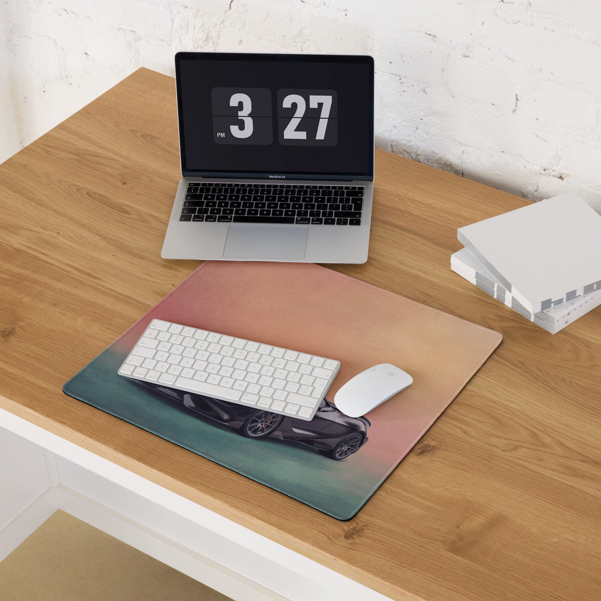 McLaren 765LT inspired stealth onyx desk mat with low friction cloth featuring a black sports car on teal to rose gold gradient