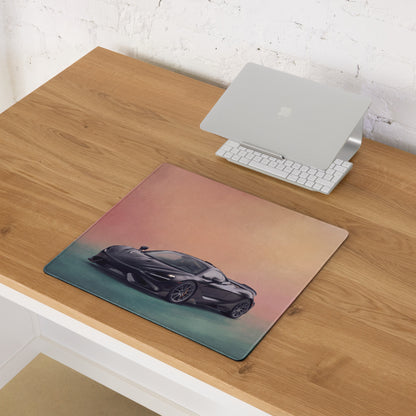 A sleek black McLaren sports car illustration printed on a gradient pink and teal low-friction cloth desk mat