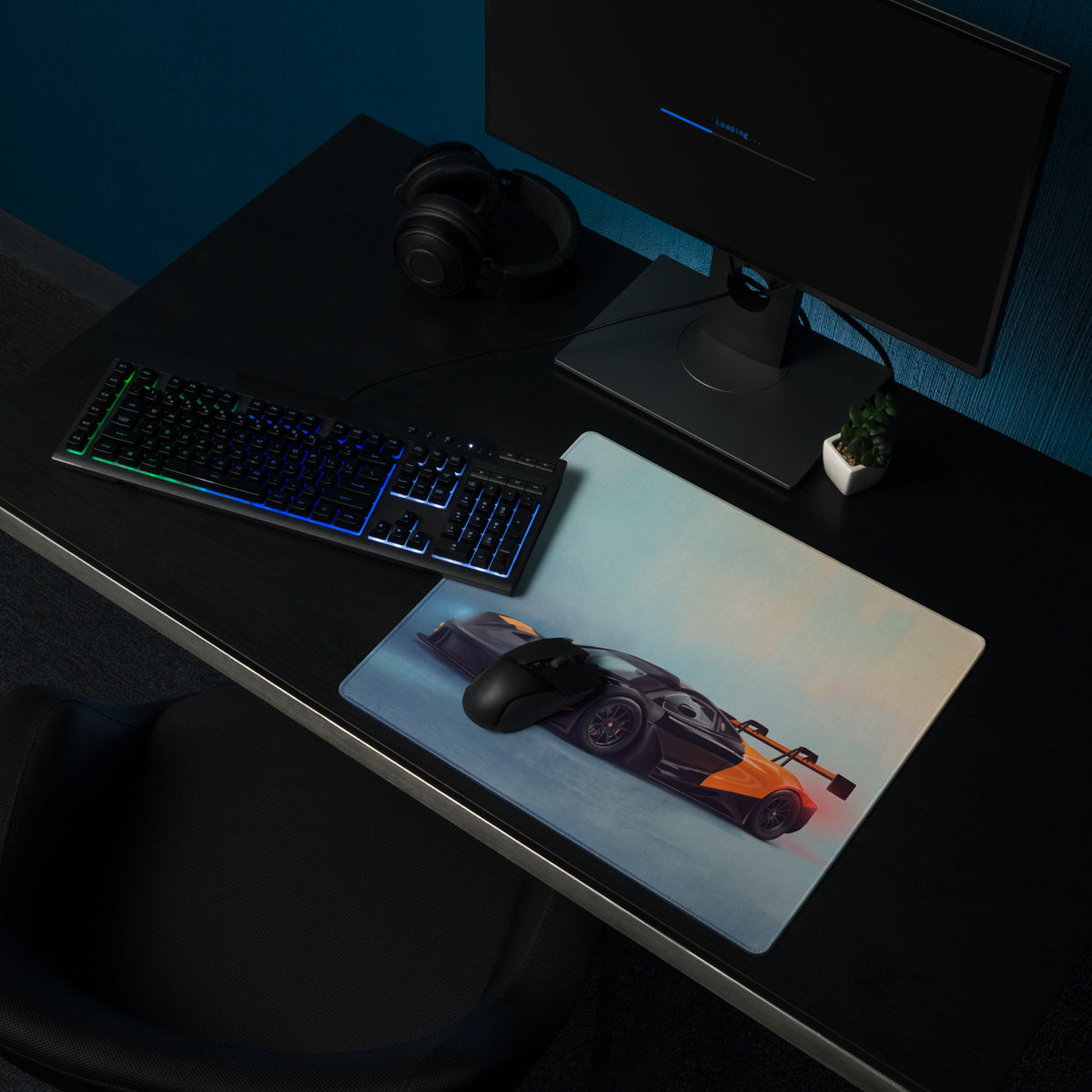 A sleek rectangular low-friction cloth gaming mousepad featuring a black and orange McLaren 720S GT3 sports car graphic