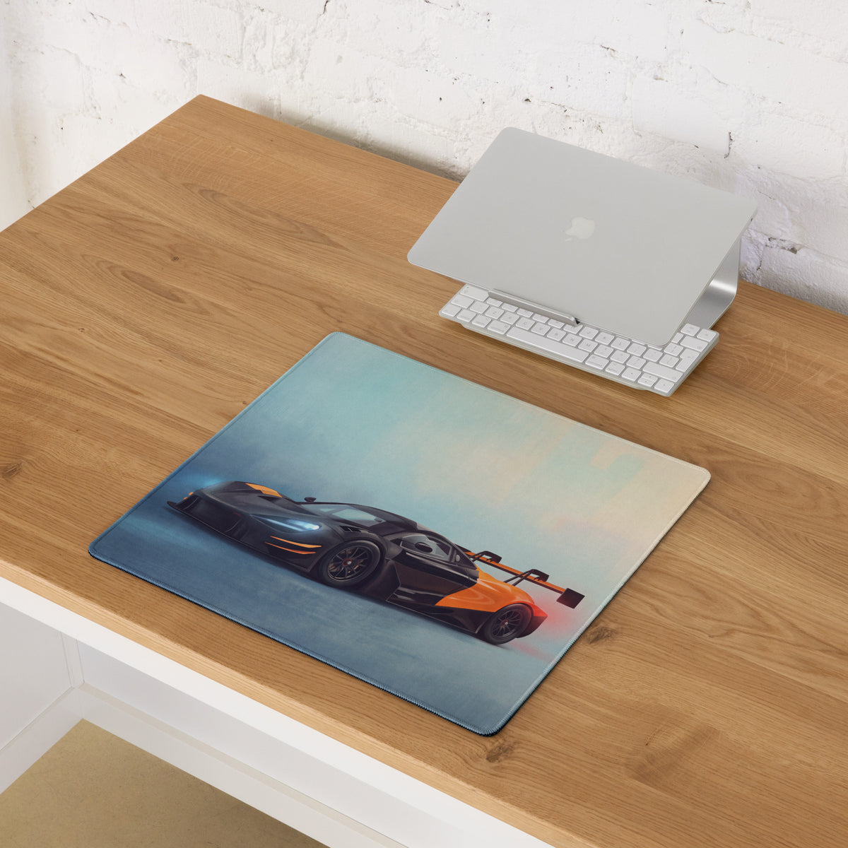 Rectangular low-friction cloth mousepad featuring a detailed black and orange mclaren 720s gt3 on a gradient blue background