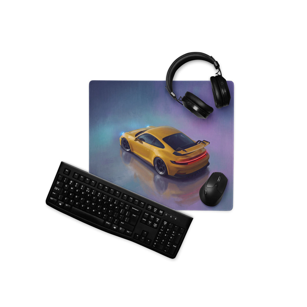 Yellow Porsche 911 GT3 inspired speed desk pad with ultra-glide stitched edge and nearby black headphones and keyboard