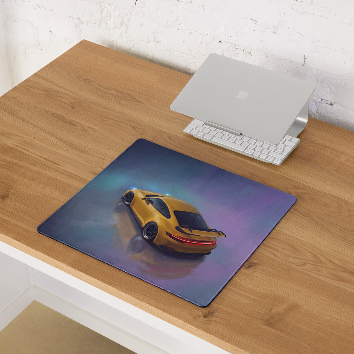 Yellow sports car graphic on porsche 911 gt3 inspired speed yellow desk pad with stitched edge and gradient background