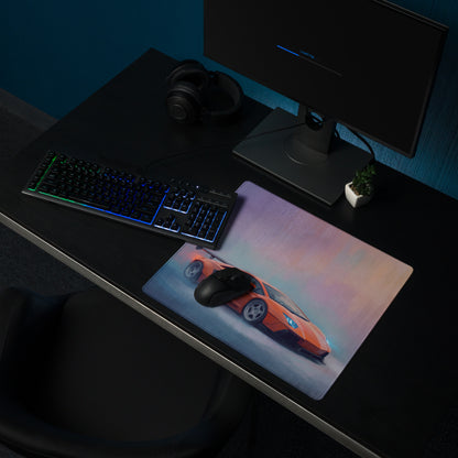 Rectangular orange sports car graphic laminated desk pad with stitched edge designed for ultra-glide gaming use