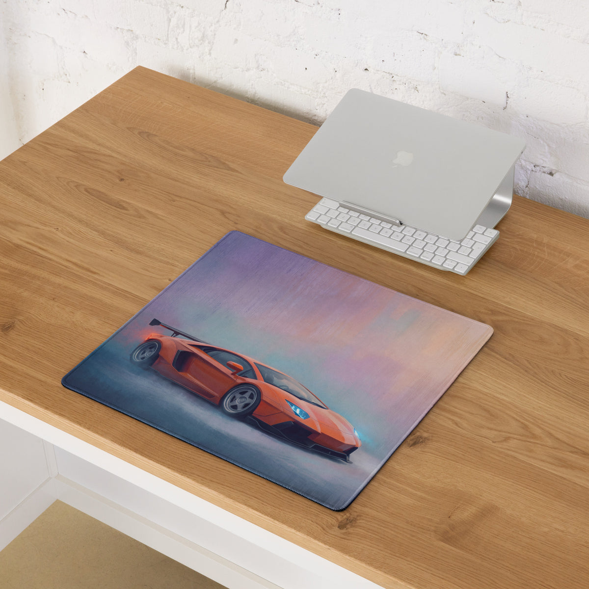 Orange sports car graphic printed on a rectangular mousepad with soft edges and subtle stitching border for gaming use