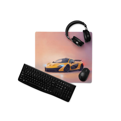 Yellow McLaren P1 inspired solar flare desk mat low-friction cloth mousepad with a sports car graphic and nearby black headphones and keyboard