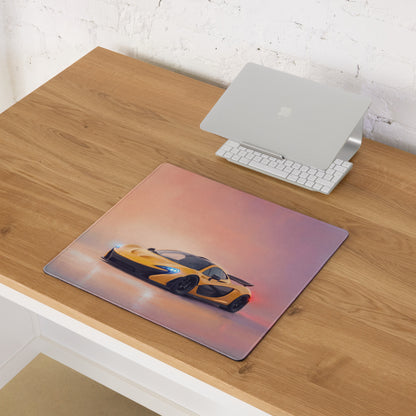 A rectangular low-friction cloth mousepad with vibrant yellow and black McLaren P1 graphic on a pink orange gradient background