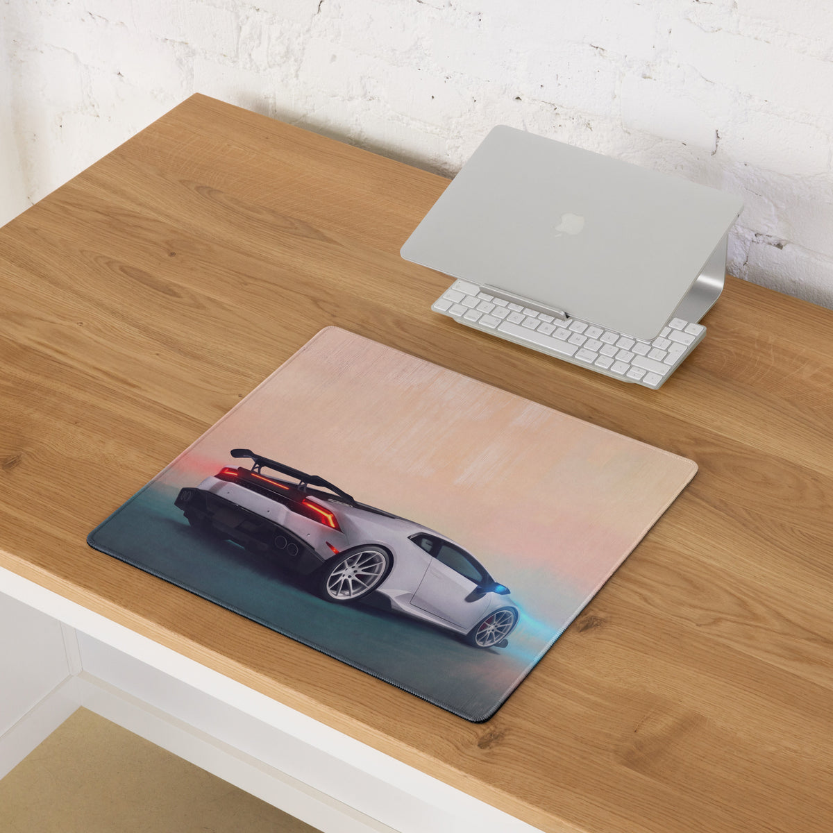 A sleek rectangular extended non slip mousepad featuring a white Lamborghini Huracán with glowing red and blue accents