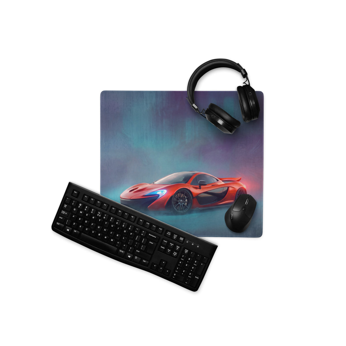 Red mclaren sports car graphic printed on volcano red xl gaming mousepad with black headphones keyboard and mouse nearby