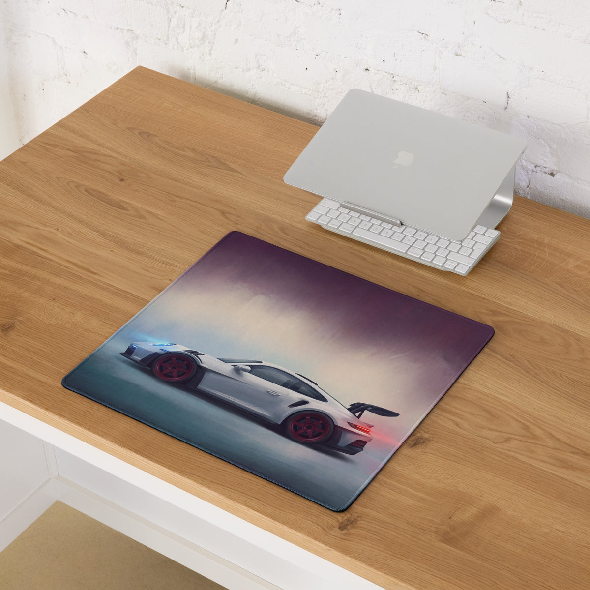 Porsche 911 gt3 rs inspired chalk red accent desk mat featuring a white sports car with red wheels on a misty track