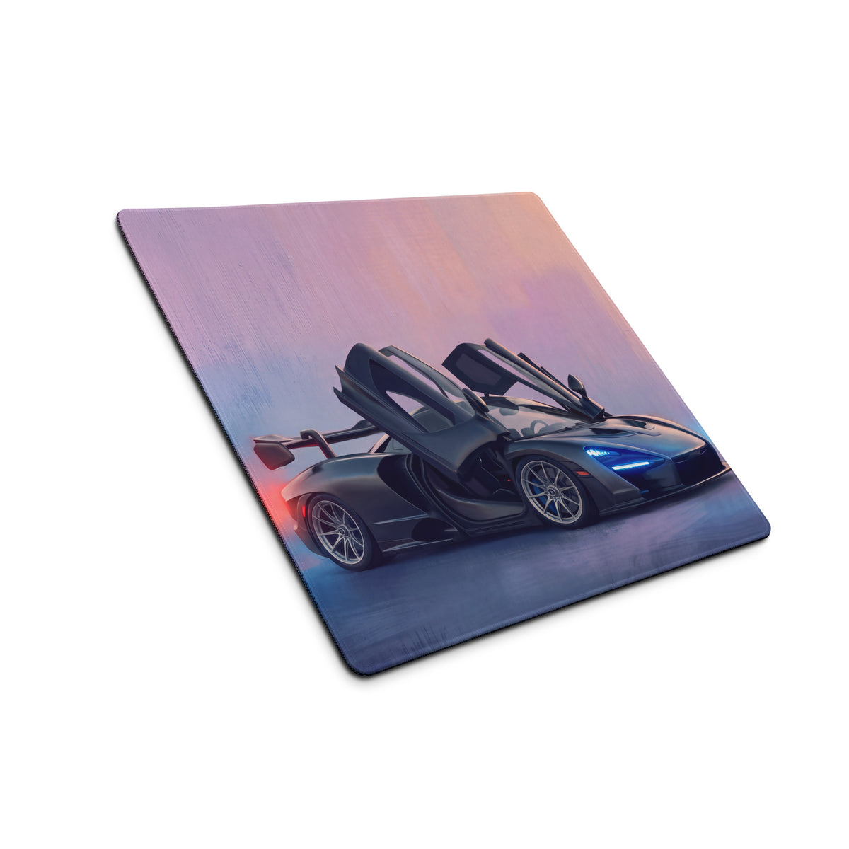 Black mclaren senna inspired stealth dihedral desk mat with low friction cloth and open doors glowing blue headlights