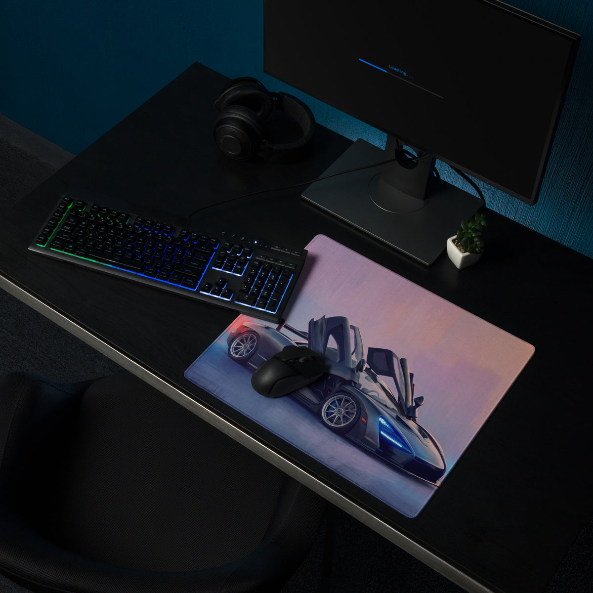A sleek rectangular low-friction cloth gaming mousepad with a vibrant blue-accented McLaren Senna sports car design