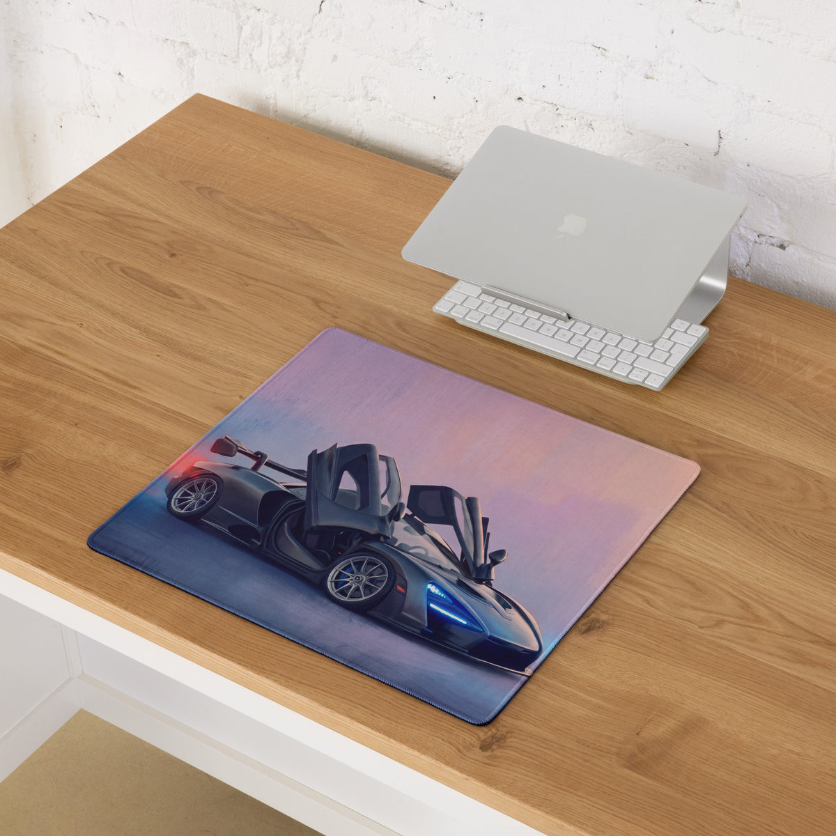 A sleek rectangular low-friction cloth mousepad featuring a vibrant black McLaren Senna sports car illustration