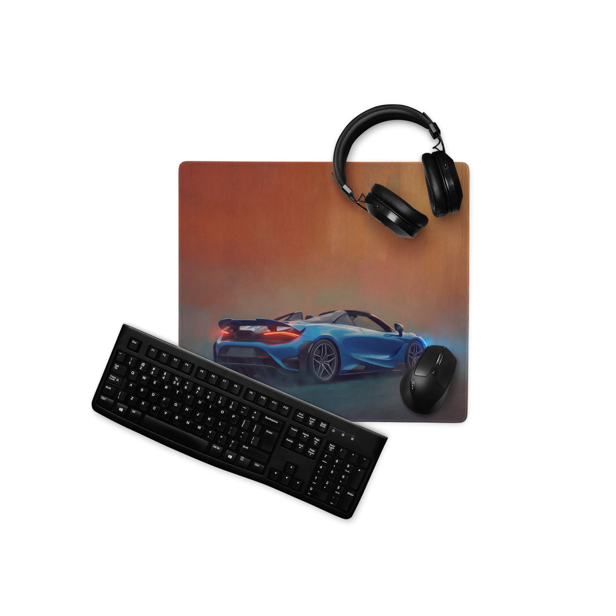 Mclaren 765lt inspired curacao blue convertible desk mat with blue sports car graphic on xl gaming mousepad next to keyboard and headphones