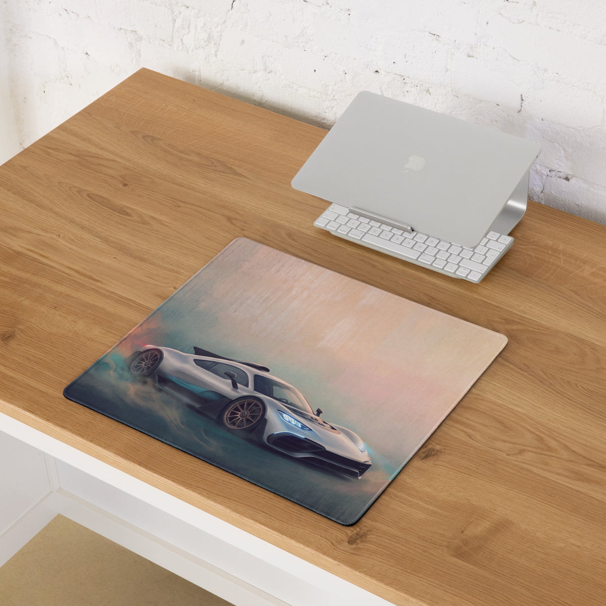 A sleek rectangular silver sports car graphic mesh stitched edge desk pad for gaming inspired by Mercedes-AMG ONE
