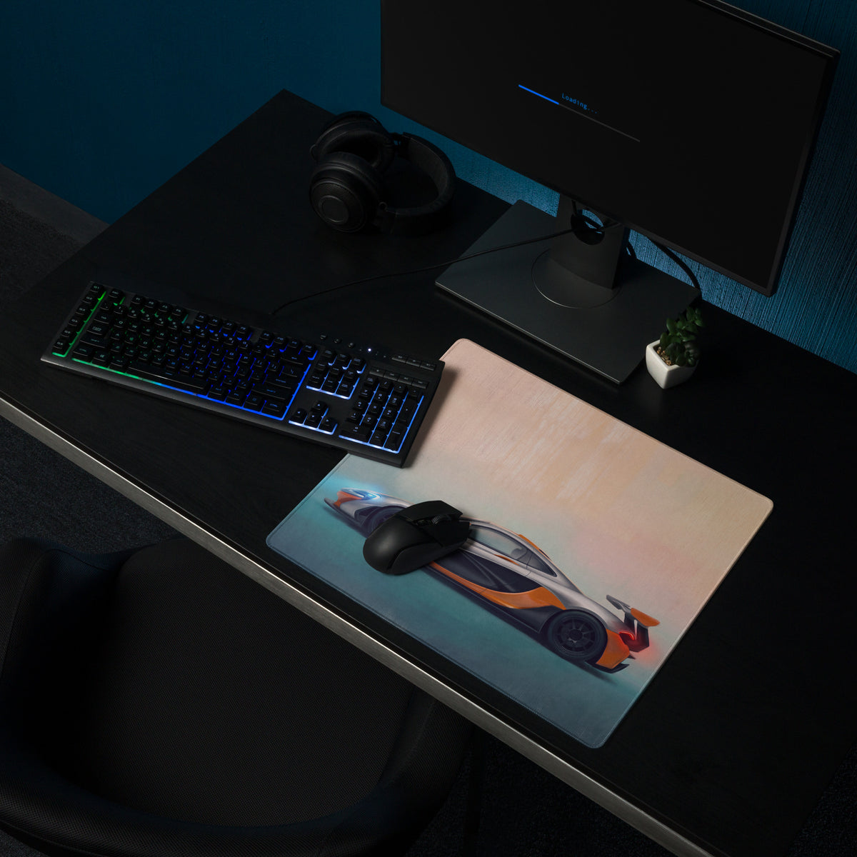 A sleek rectangular low-friction cloth gaming mousepad with a vibrant orange and black McLaren P1 sports car illustration