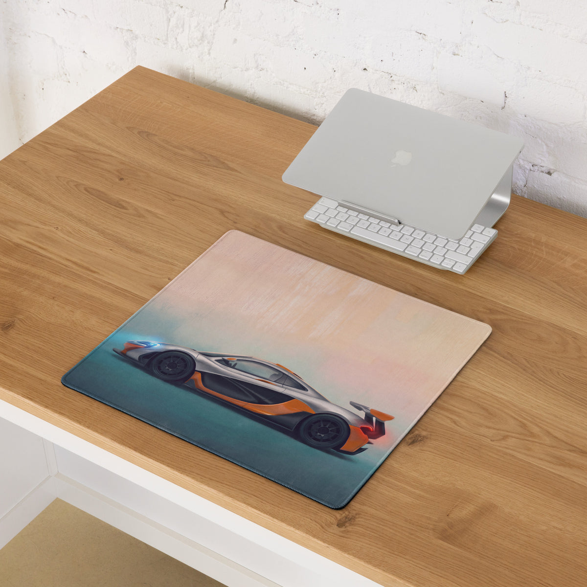 Rectangular low-friction cloth mousepad featuring a vibrant orange and silver McLaren P1 illustration on gradient sky background