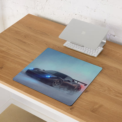 Rectangular stealth matte black desk pad featuring a glossy dark blue sports car with glowing headlights and red taillights