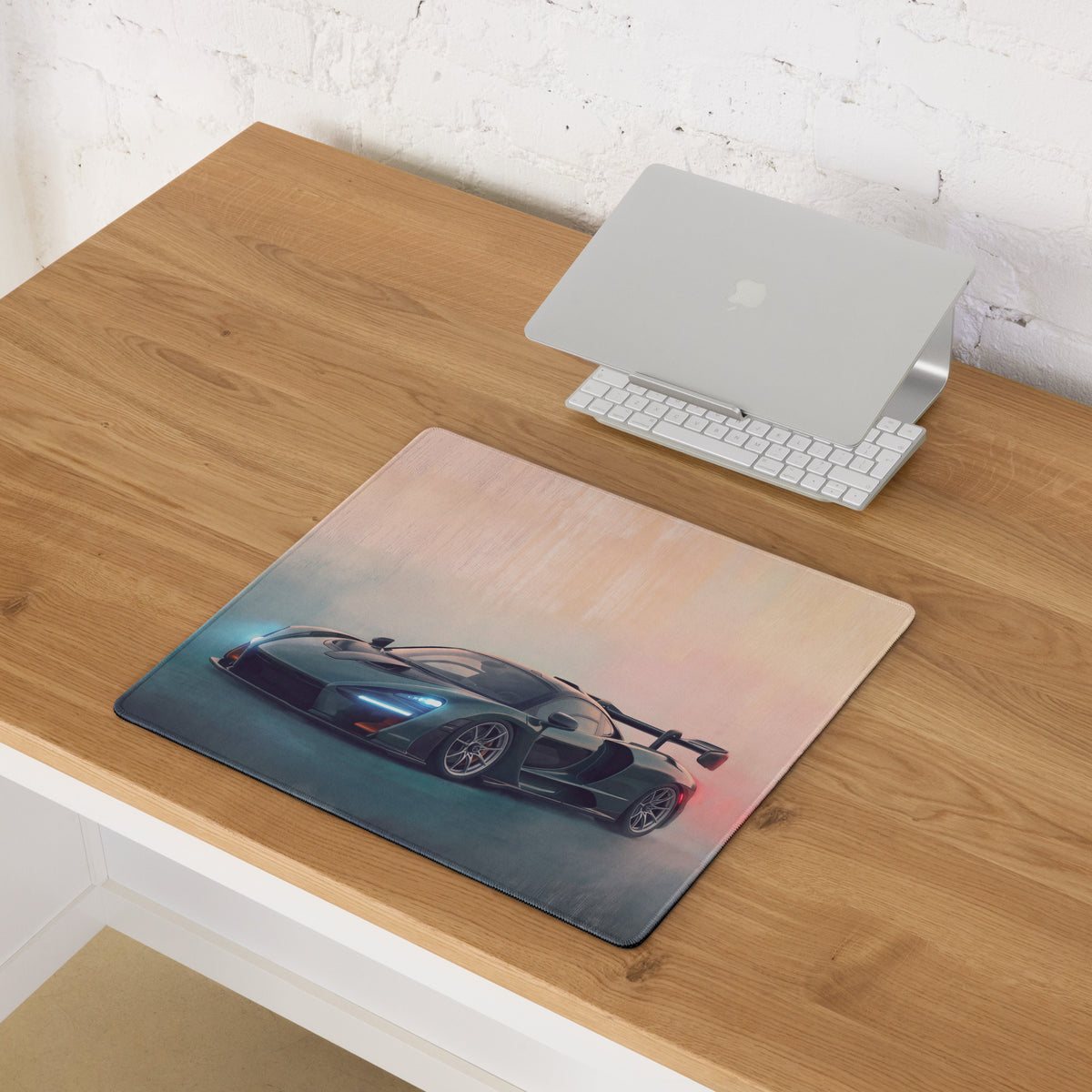 A sleek dark green mclaren senna inspired sports car graphic on a low friction cloth british racing green desk mat mousepad