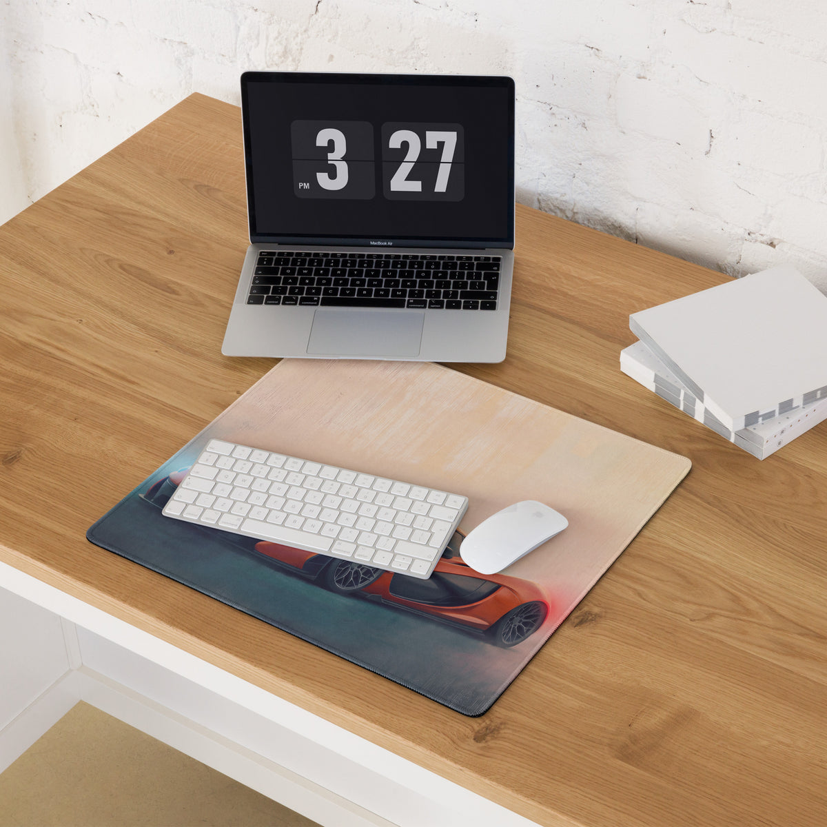 Rectangular mclaren p1 inspired volcano horizon desk pad with vibrant orange sports car design and stitched edges on wood desk