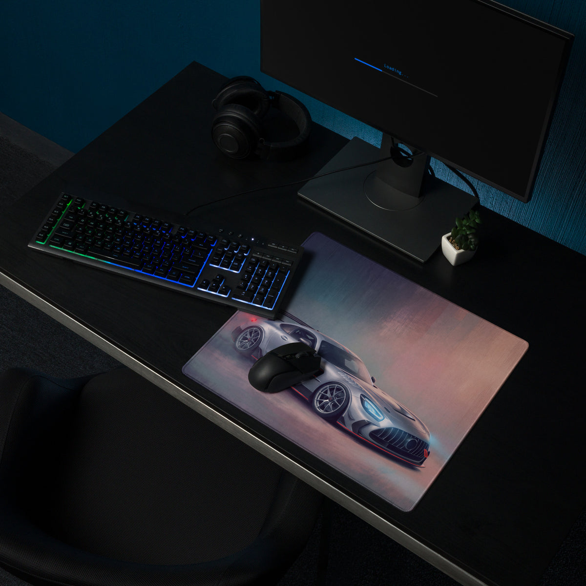 A sleek rectangular gaming mousepad with stitched edges featuring a silver and black Mercedes-AMG GT graphic