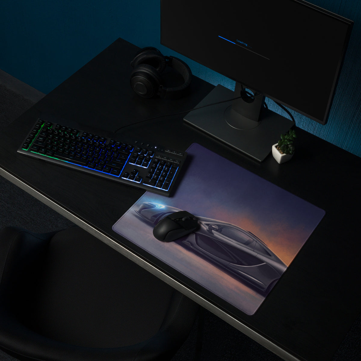 A sleek charcoal gaming mousepad featuring a vibrant futuristic mclaren p1 sports car graphic under twilight sky