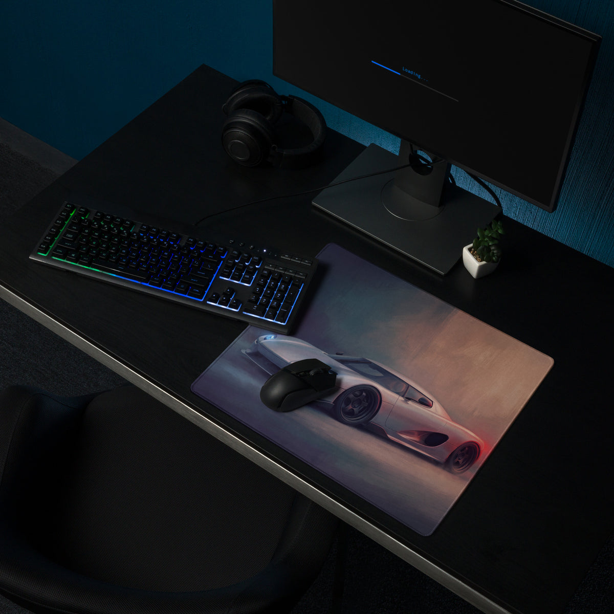 A sleek silver koenigsegg ccx inspired desk mat with low-friction surface featuring a white hypercar print